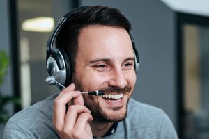 Man in headset using cloud telephone system s in Northern Ireland