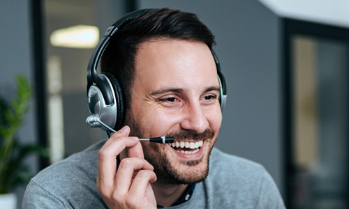 Man in headset using cloud telephone system in Northern Ireland